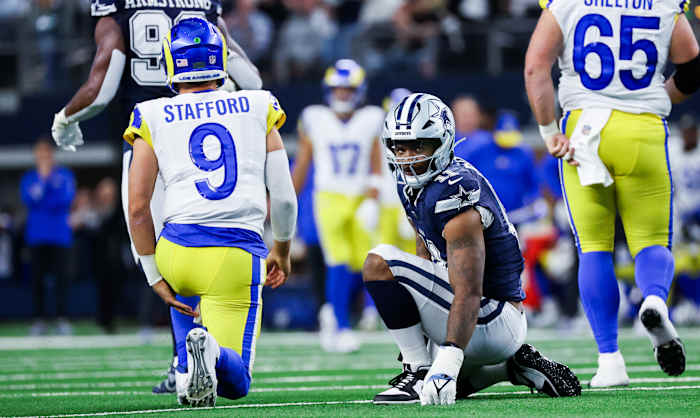 Dallas Cowboys linebacker Micah Parsons (11) reacts in front of Los Angeles Rams quarterback Matthew Stafford (9) during the first half at AT&T Stadium.